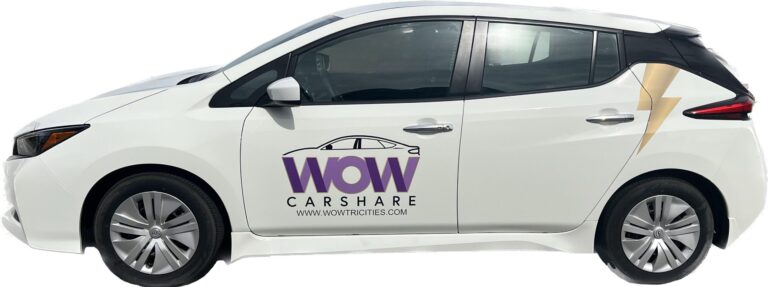 A white Nissan Leaf with WOW EV Car Share branding