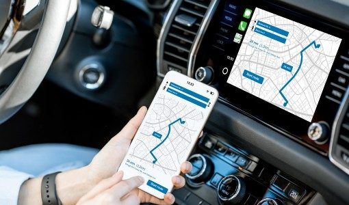 A driver syncing phone GPS navigation with in-dash display